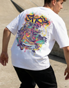 Person wearing a white t-shirt with colorful graphics at a skate park